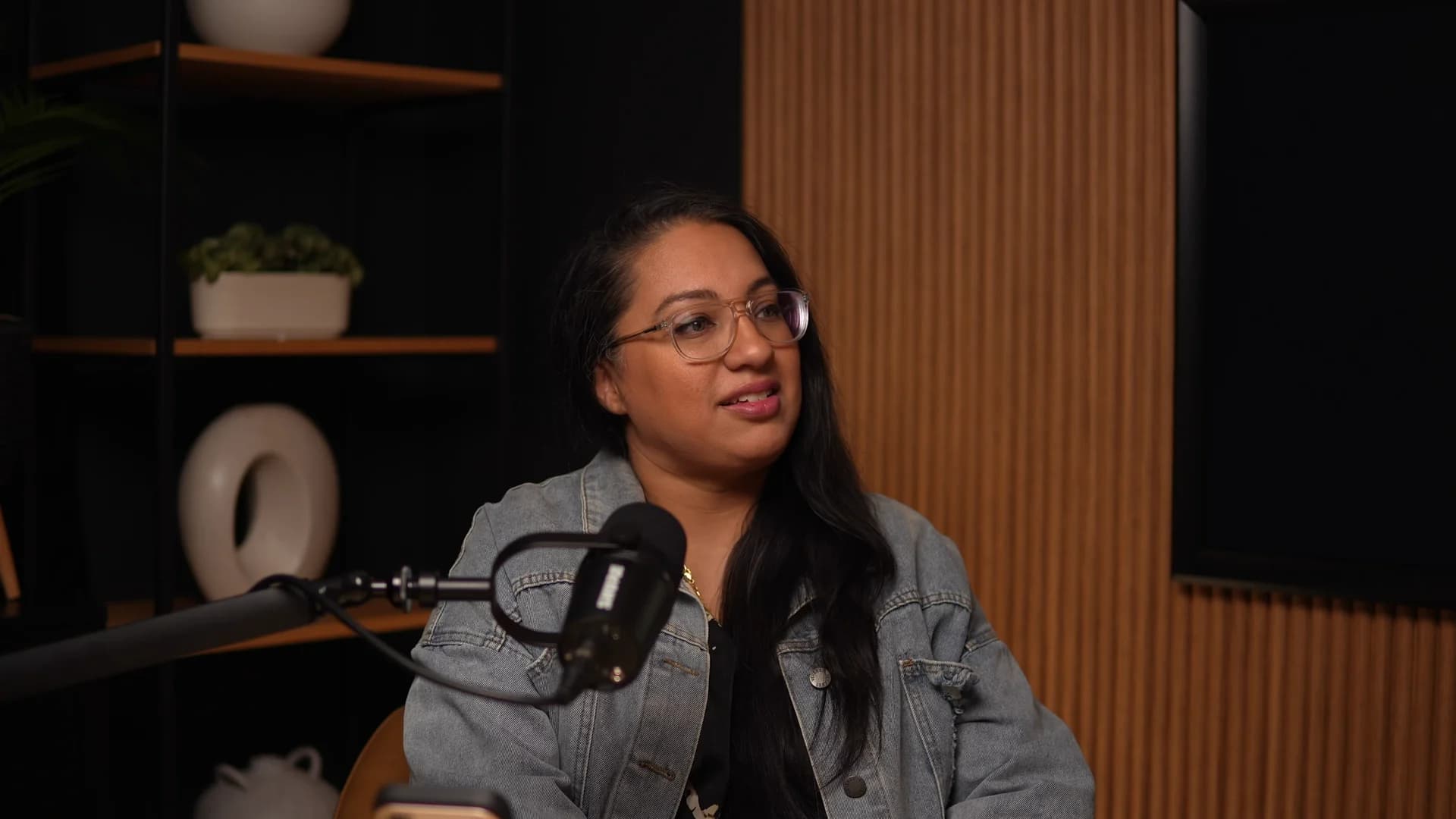 A client recording a podcast in The Den