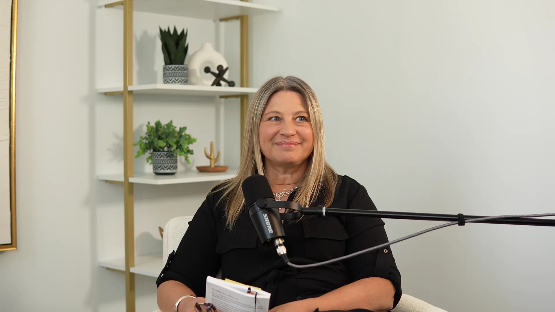 A podcast guest speaking at a microphone in The Gallery