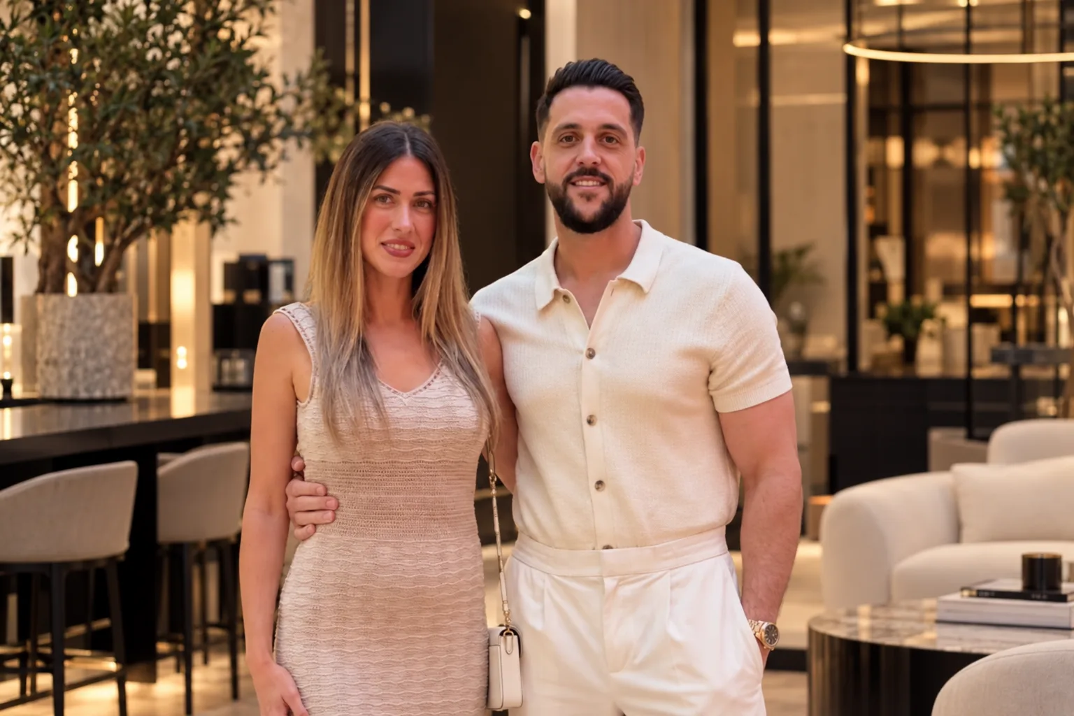 Natasha and Marco Moutinho standing together, smiling at the camera